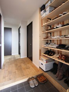 there are many pairs of shoes on the shelves in this room, and one is empty