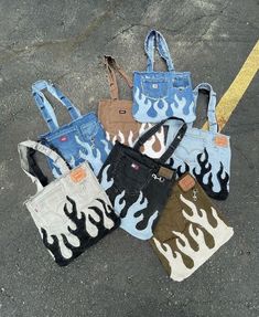 five purses with flames on them sitting in the middle of an empty parking lot