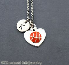 a heart shaped necklace with a basketball on it