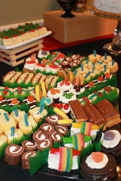 a table topped with lots of cakes and desserts