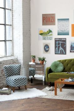 a living room filled with furniture and pictures on the wall