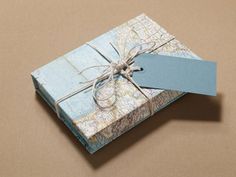 a map wrapped in blue paper with a tag attached to the side and tied up