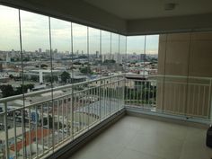 an empty balcony overlooking a city with lots of windows and balconies in the foreground