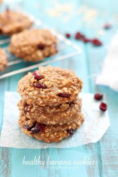 three oatmeal cookies stacked on top of each other with cranberries