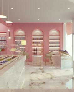 the interior of a nail salon with pink walls and marble floors