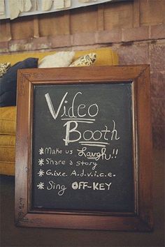 a chalkboard sign sitting in front of a yellow couch