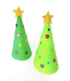 two green plastic christmas trees with gold stars