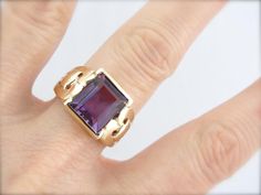 This stunning vintage ring features a luscious Amethyst center, square cut with a lot of glimmer! The simple mounting features beautiful filigree swirl cut-out shoulders that really make this unique and special! Metal: 10K Yellow Gold Gem: Amethyst 4.93 Carats Gem Measurements: 9.9 x 10.6 mm, Rectangle Ring Size: 7.75 Marks: "10K" Stamped on the inside band Elegant Rectangular Amethyst Ring For Formal Occasions, Square Cut Amethyst Ring For Formal Occasions, Formal Square Cut Amethyst Ring, Elegant Amethyst Ring With Rectangular Stone For Formal Occasion, Elegant Formal Amethyst Ring With Rectangular Stone, Formal Purple Amethyst Ring With Rectangular Shape, Formal Rectangular Amethyst Ring, Formal Rectangular Purple Amethyst Ring, Classic Amethyst Ring With Rectangular Stone For Formal Occasions