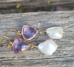 These elegant gold amethyst faceted crystals and  big baroque pearls earrings are  great for everyday use, parties, or for special occasions! It is made with big genuine baroque pearls, wire wrapped in gold filled wires, measures 9mm to 12 mm x 15mm to 17mm (big baroque, light). The color is natural white, pearls are lustrous. The pearl is attached to a amethyst purple glass connector bezel gold rhodium plated connector.  Material: Genuine Baroque Pearls, lustrous, wrinkled Size: 9mm to 12 mm x 15mm to 17mm Finding: gold plated ; amethyst  purple glass bezel connector. Length ( with ear hooks) is around 2 inches (  50 mm ). Note: Your jewelry will arrive beautifully and carefully packaged in a gift box with a pretty ribbon. Elegant Amethyst Earrings As A Gift, Handmade Amethyst Wedding Earrings, Handmade Amethyst Earrings For Wedding, Wedding Amethyst Earrings With Natural Stones, Elegant Gold Amethyst Crystal Earrings, Gold Amethyst Earrings For Parties, Gold Amethyst Drop Earrings, Gold Amethyst Crystal Earrings, Gold Amethyst Crystal Earrings With Gemstone