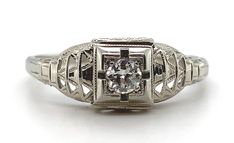 All of our jewelry is guaranteed authentic by our Graduate Gemologist of the Gemological Institute of America (GIA). 18k White Gold Filigree Genuine Natural Diamond Ring Chevron Like Design #J5946 Art Deco 18k white gold diamond filigree ring. The diamond is European cut and weighs about .10cts. The ring fits a size 7 1/2 finger, weighs 1.13 dwt., and dates from the 1920s. Wonderful! SKU#J5946. 100% Satisfaction Guaranteed! Elegant Engraved Diamond Ring For Formal Occasions, Luxury Formal Filigree Ring With Single Cut Diamonds, Elegant Diamond Filigree Ring With Engraving, Formal Diamond Filigree Ring With Engraving, Formal Engraved Diamond Filigree Ring, Elegant Engraved Diamond Filigree Ring, Engraved White Gold Filigree Ring, Engraved Filigree Ring For Formal Occasions, Luxury Filigree Diamond Ring For Formal Occasions