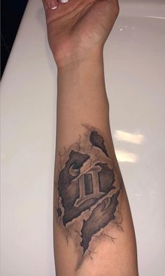 a person's arm with a tattoo on it that has a hole in the middle