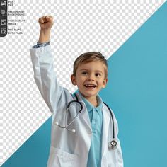 a young boy in a doctor's coat raising his fist up