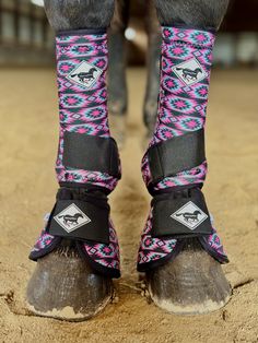 the legs and feet of a horse wearing boots with colorful patterns on it's ankles