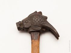 an old hammer with a fish head on it