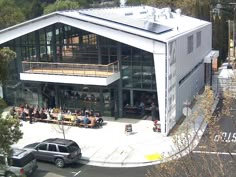 an aerial view of a building with people eating outside