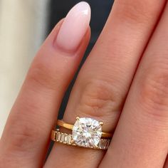 a woman's hand with a ring on it and a diamond in the middle