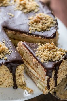 a cake with chocolate frosting and crumbs on it sitting on a plate