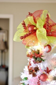 a christmas tree decorated with red, yellow and green decorations