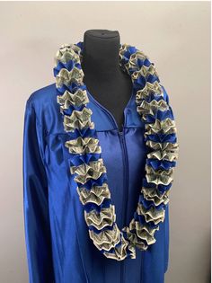 a woman's blue graduation gown with ruffles on the neck and sleeves