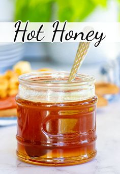 a jar filled with honey sitting on top of a table