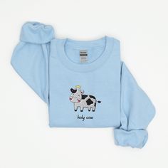 Holy Cow Sweatshirt, Embroidered Cow Crewneck Sweatshirt, Holy Cow Shirt, Funny Sweatshirt, Funny Embroidered Shirt This embroidered holy cow crewneck sweatshirt is everything. Please let me know if you would like extended sizing (3X-5X), I have certain color and size options available! ✨ 50% cotton, 50% polyester ✨ Pre-shrunk ✨ Classic fit Care: Machine wash: warm (max 40C or 105F) Tumble dry: low Do not iron directly on the print REFUNDS AND EXCHANGES All items are made to order using multiple Blue Embroidered Crew T-shirt, Blue Long Sleeve T-shirt With Embroidered Text, Embroidered Cotton Crew T-shirt, Embroidered Cotton Crew Top, White Long Sleeve Shirt With Embroidered Logo, Casual Long Sleeve Shirt With Custom Embroidery, Casual Long Sleeve Shirt With Embroidered Logo, Blue Embroidered T-shirt For Fall, Cotton Long Sleeve Shirt With Embroidered Text