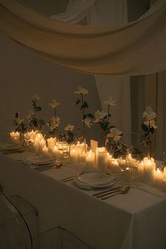 the table is set with candles and flowers