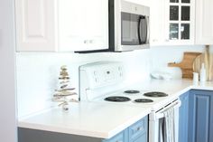 a kitchen with blue cabinets and white counter tops