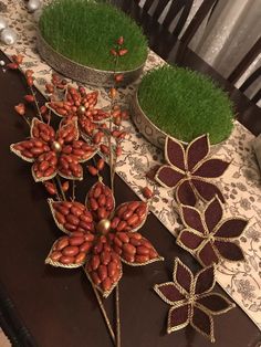 decorative flowers and grass are on the table