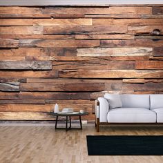 a white couch sitting in front of a wooden wall