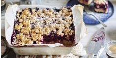 a blueberry crumble cake sitting on top of a table