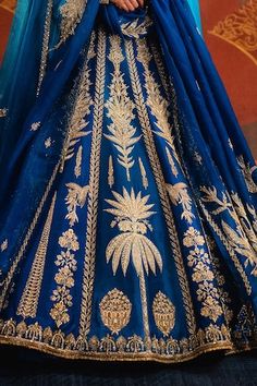 Navy blue lehenga featuring zardozi, cutdana embroidery in sehar and sitara motif. Paired with an embroidered, back tie-up detailed blouse, two dupattas and separate cancan skirt. - Aza Fashions Royal Blue Dresses For Wedding And Navratri, Royal Blue Wedding Dress For Navratri, Blue Semi-stitched Sharara With Motifs, Blue Semi-stitched Motif Sharara, Royal Blue Lehenga With Intricate Embroidery For Wedding, Royal Blue Wedding Lehenga With Intricate Embroidery, Blue Gown With Intricate Embroidery For Festivals, Semi-stitched Blue Lehenga With Motifs, Royal Blue Lehenga With Intricate Embroidery