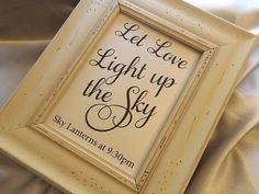 a white framed sign that says let love light up the sky with black lettering on it