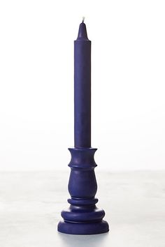 a tall blue candle sitting on top of a table