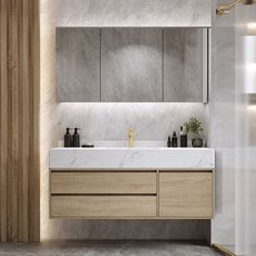 a modern bathroom with marble counter tops and wooden cabinetry, along with two sinks