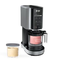 the ninja coffee maker is next to a container with powdered sugar in it on a white background