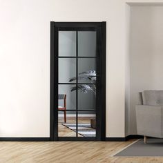 an empty living room with a couch and glass door