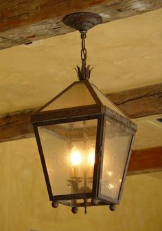 an old fashioned light hanging from the ceiling