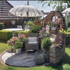 an outdoor patio with chairs, umbrella and potted plants