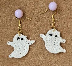 Introducing the Spirited Stitch Ghost Earrings--a delightful blend of whimsy and charm, perfect for adding a touch of cute spookiness to your style. These hand-crocheted earrings feature delicate, ghostly figures that are both small and dainty, making them an ideal accessory for any occasion. Black beaded eyes add a touch of sparkle as they move with you, elevating your look. Each ghost is meticulously crafted from 100% cotton thread, ensuring they're lightweight enough to comfortably wear all day long. Perfect for Halloween or adding a bit of playful spirit to your everyday look, the Spirited Stitch Ghost Earrings are a must-have for anyone who loves a blend of spooky and sweet. Whether you're treating yourself or gifting a loved one, these earrings are sure to enchant and delight!  Spiri Handmade Spooky Earrings For Gift, Handmade Halloween Earrings Gift, Handmade Dangle Earrings For Halloween, Quirky Handmade Halloween Jewelry, Handmade White Earrings For Halloween, Handmade Novelty White Earrings, Quirky Handmade Dangle Earrings, Cute Handmade Halloween Jewelry, Whimsical Handmade Earrings For Halloween