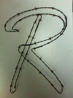 the letter k is made up of barbed wire