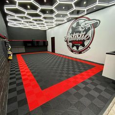 the inside of a skateboard shop with black and white checkered flooring, red lines