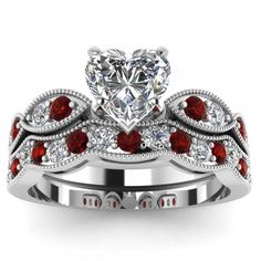 a white gold ring with red stones on it