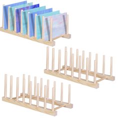 four wooden pegs with different colored papers on them