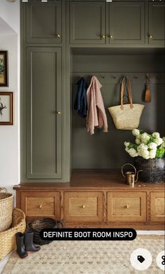 an image of a room with green cupboards and shoes on the floor in front of it