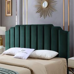 a green headboard on a bed in a room with purple walls and white pillows