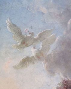 two white doves are flying in the sky