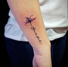 a woman's arm with a flower tattoo on it