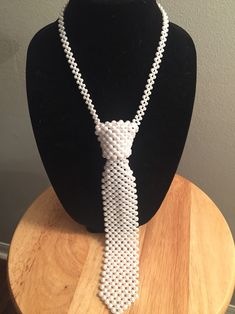 Unisex pearl neck tie (new style) Available in white and off white. If you want off white please message me your request or otherwise the white will be sent automatically. if you would like any other colors than white and cream it will be a special order special order requests only! see last picture for color chart choose any color on the color chart for tie color. Please allow 2 weeks processing since these colors will be special ordered. Elegant White Formal Ties, Pearl Neck, Wire Diy, Tie Colors, Beaded Necklaces, Diy Accessories, Bead Crafts, New Style, Wire Jewelry