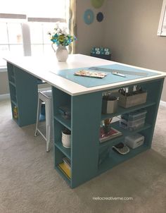 a kitchen island made out of an office desk with drawers and shelves on the top