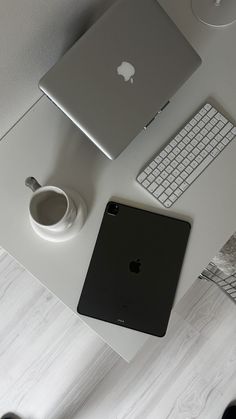 an apple laptop computer sitting on top of a white desk